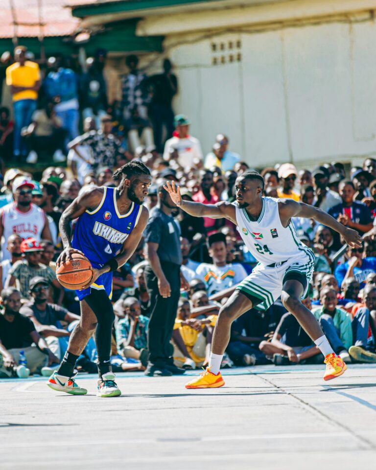 Captivating outdoor basketball game with players in motion, surrounded by an enthusiastic crowd.